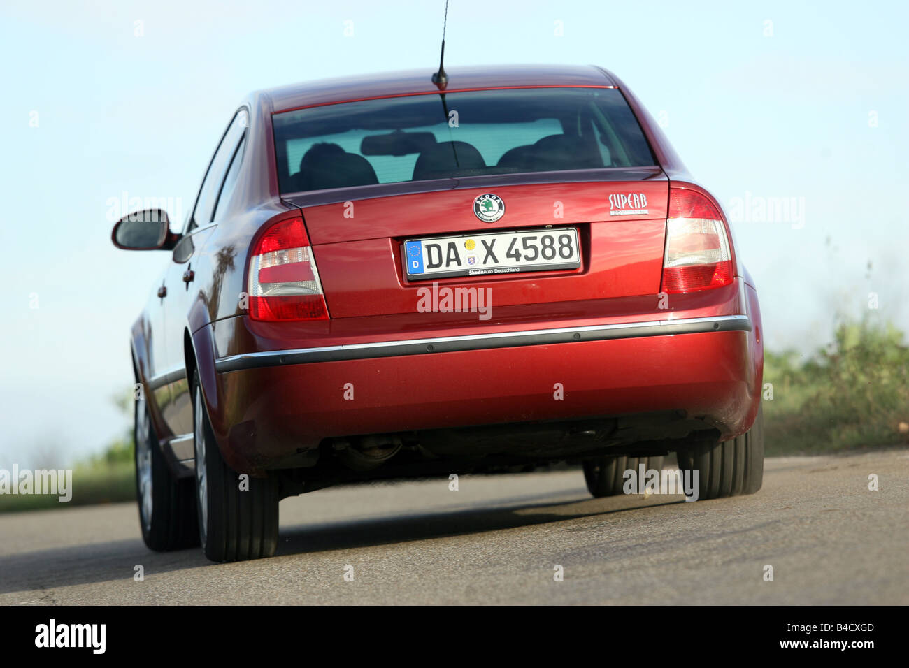 Skoda Superb 1.8 Turbo Elegance, red, model year 2006-, driving, diagonal from the back, rear view, country road Stock Photo