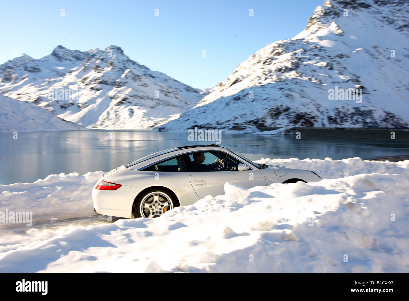 Porsche 911 Targa 4S, model year 2006, white, driving, side view, Snow, Winter, landsapprox.e, Mountains Stock Photo