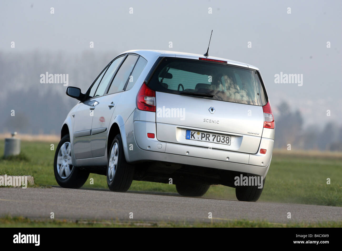 Renault Grand Scénic XXL 2.0 dCi, model year 2006-, ruby colored, driving,  diagonal from the back, rear view, country road Stock Photo - Alamy