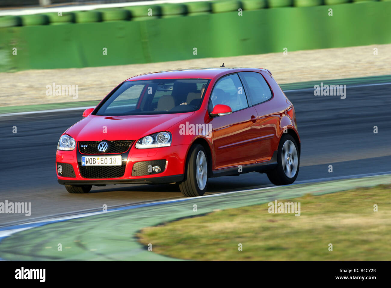 VW Volkswagen Golf GTI, model year 2004-, red, driving, diagonal from the front, frontal view, test track Stock Photo