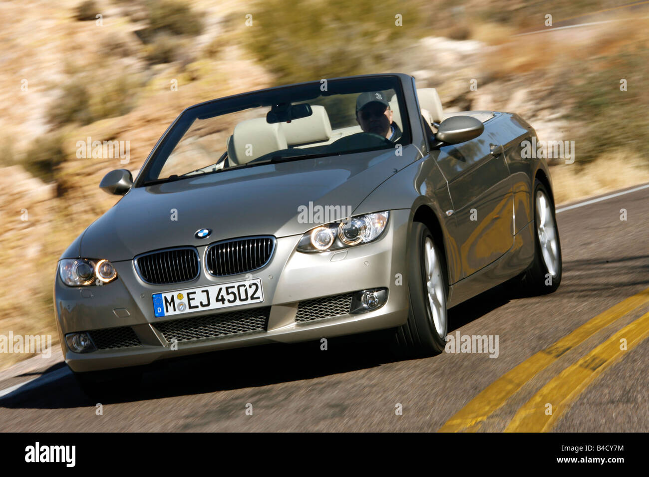 BMW 335i Convertible, model year 2007-, driving, diagonal from the front, frontal view, country road, open top Stock Photo