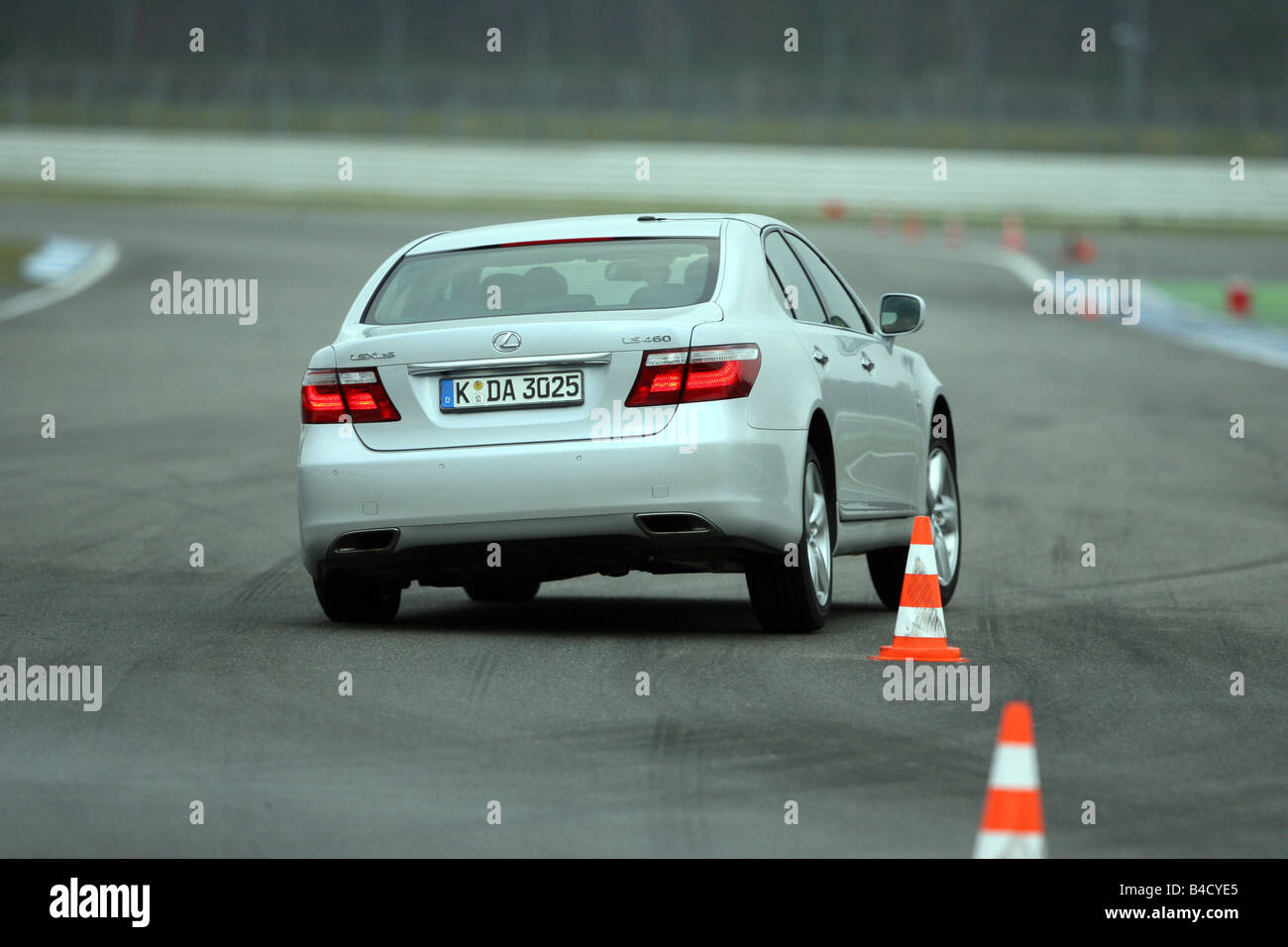 Lexus LS 460 Ambience Impression, model year 2007-, white, driving, diagonal from the back, rear view, Pilonen, test track Stock Photo