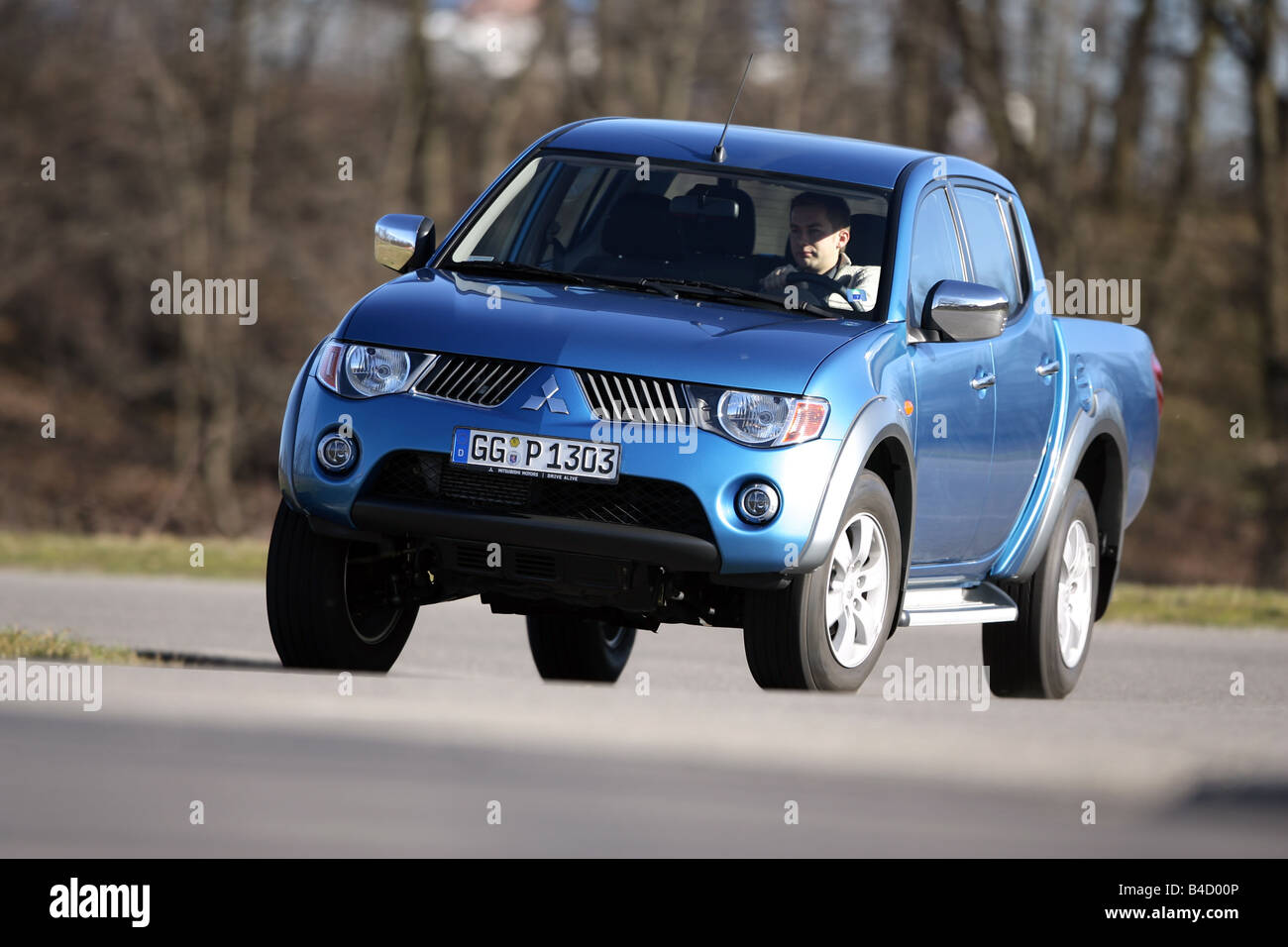 Mitsubishi L200 2.5 DI-D Doppelkabine Intense, model year 2007-, blue moving, diagonal from the front, frontal view, country roa Stock Photo