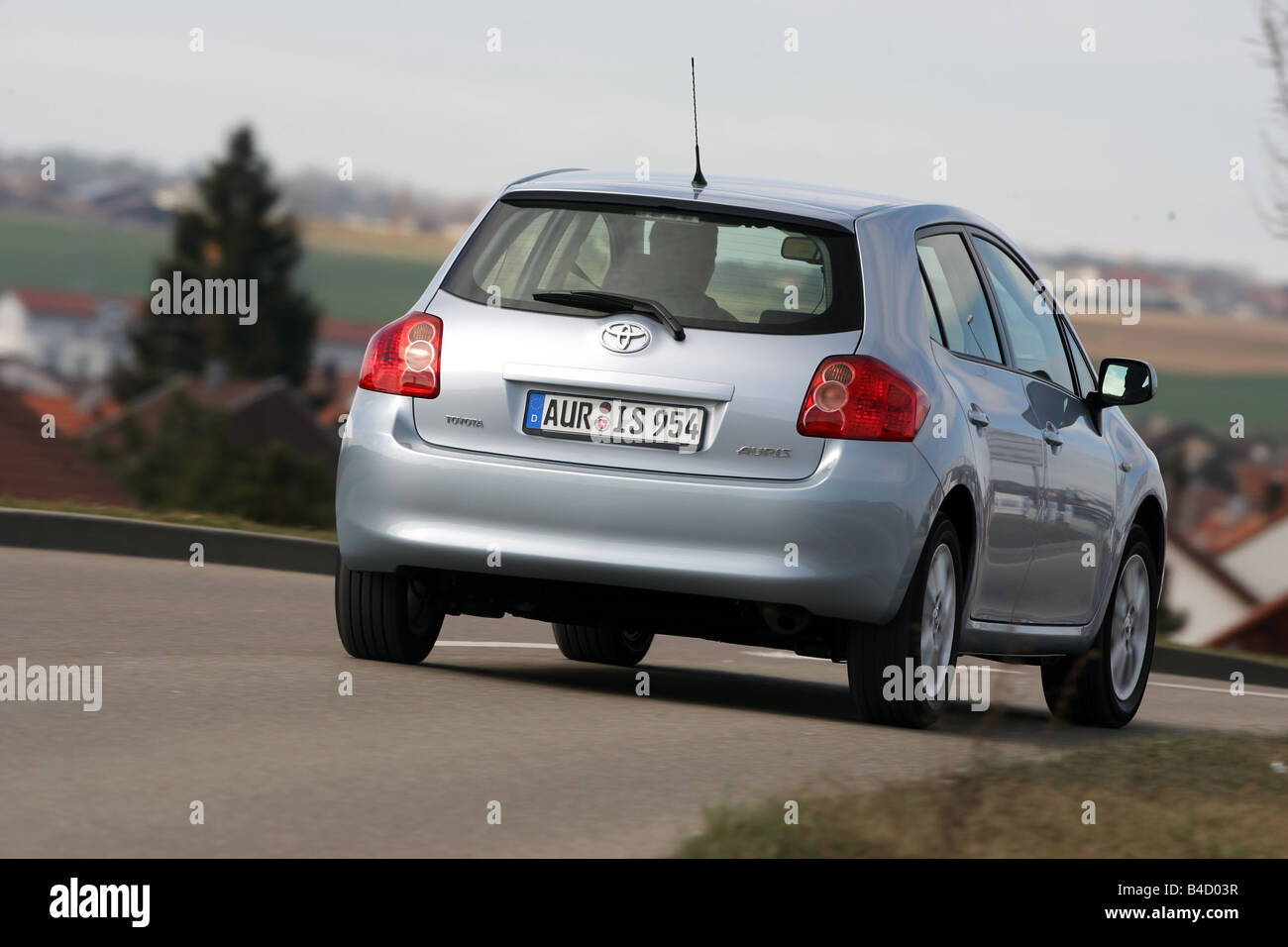 Toyota Auris 1.6 Dual VVT-i Executive, model year 2007-, silver, driving,  diagonal from the back, rear view, country road Stock Photo - Alamy