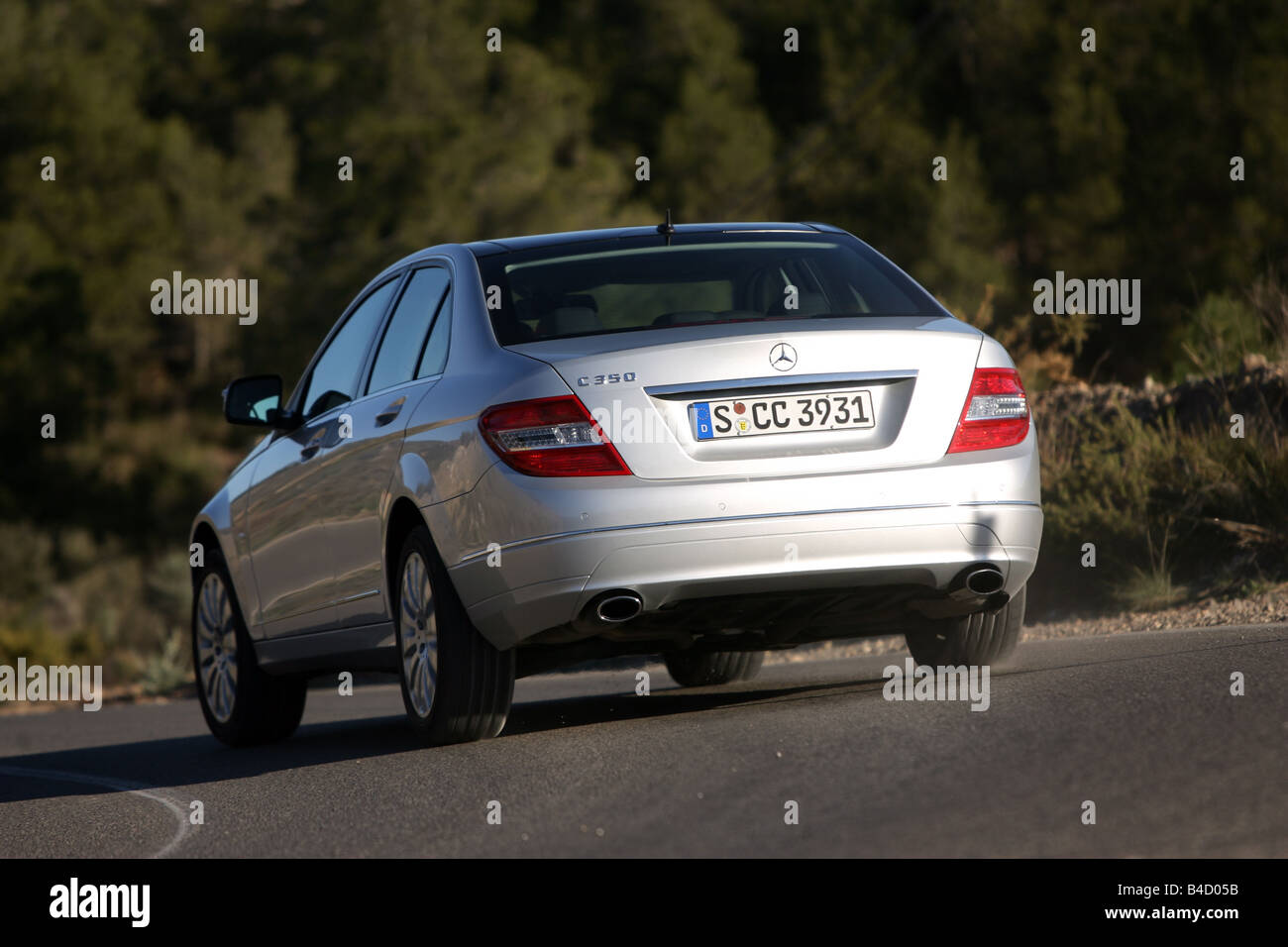 Mercedes C class, model year 2007, silver, driving, diagonal from the back, rear view, country road Stock Photo