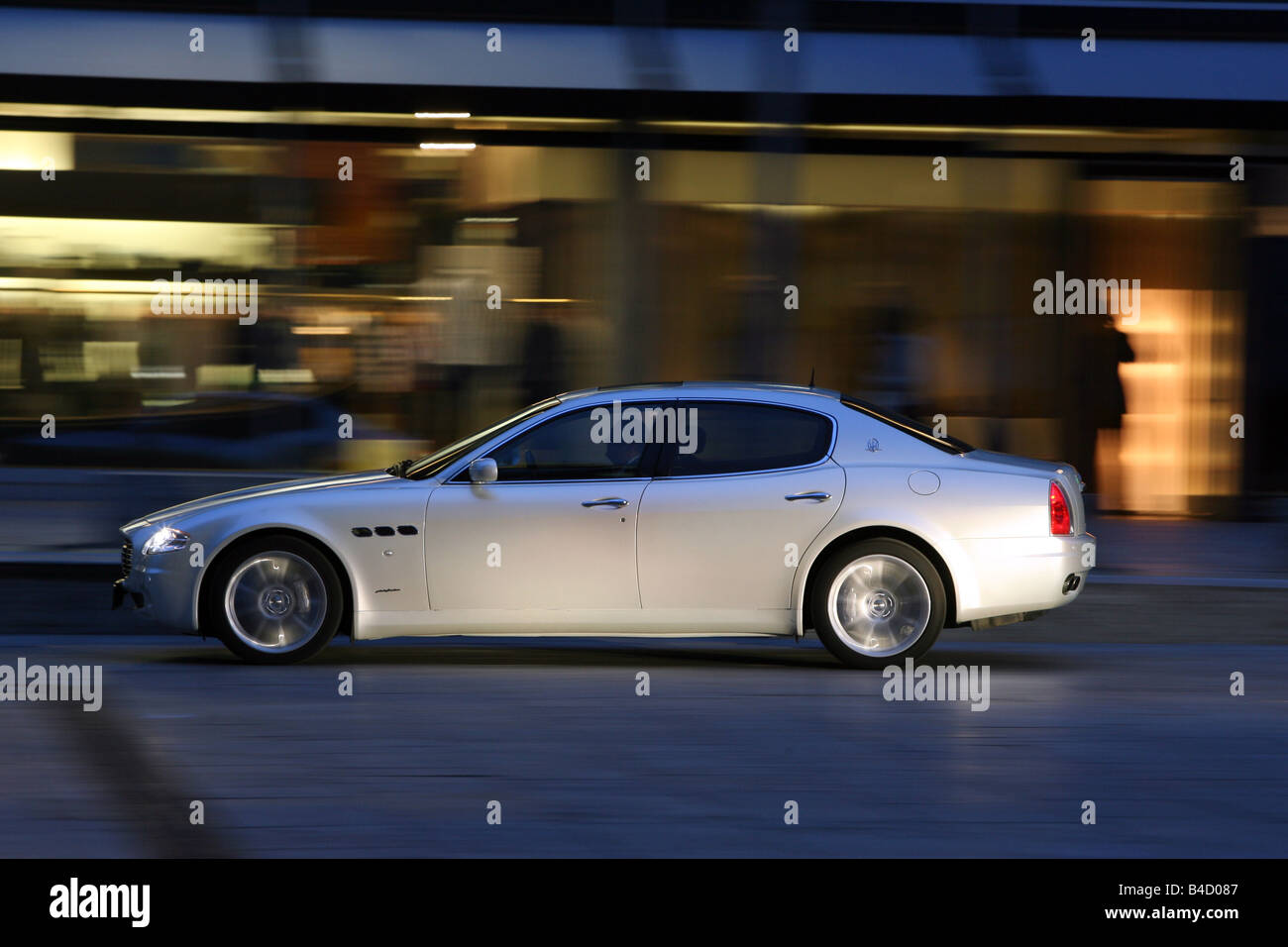Maserati Quattroporte automatic, model year 2007-, white, driving, side view, City Stock Photo