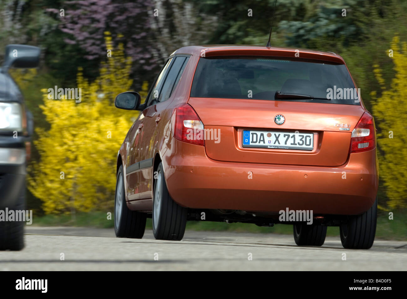 Skoda Fabia 1.4 16V Sport, model year 2007-, orange , driving, diagonal  from the back, rear view, country road Stock Photo - Alamy