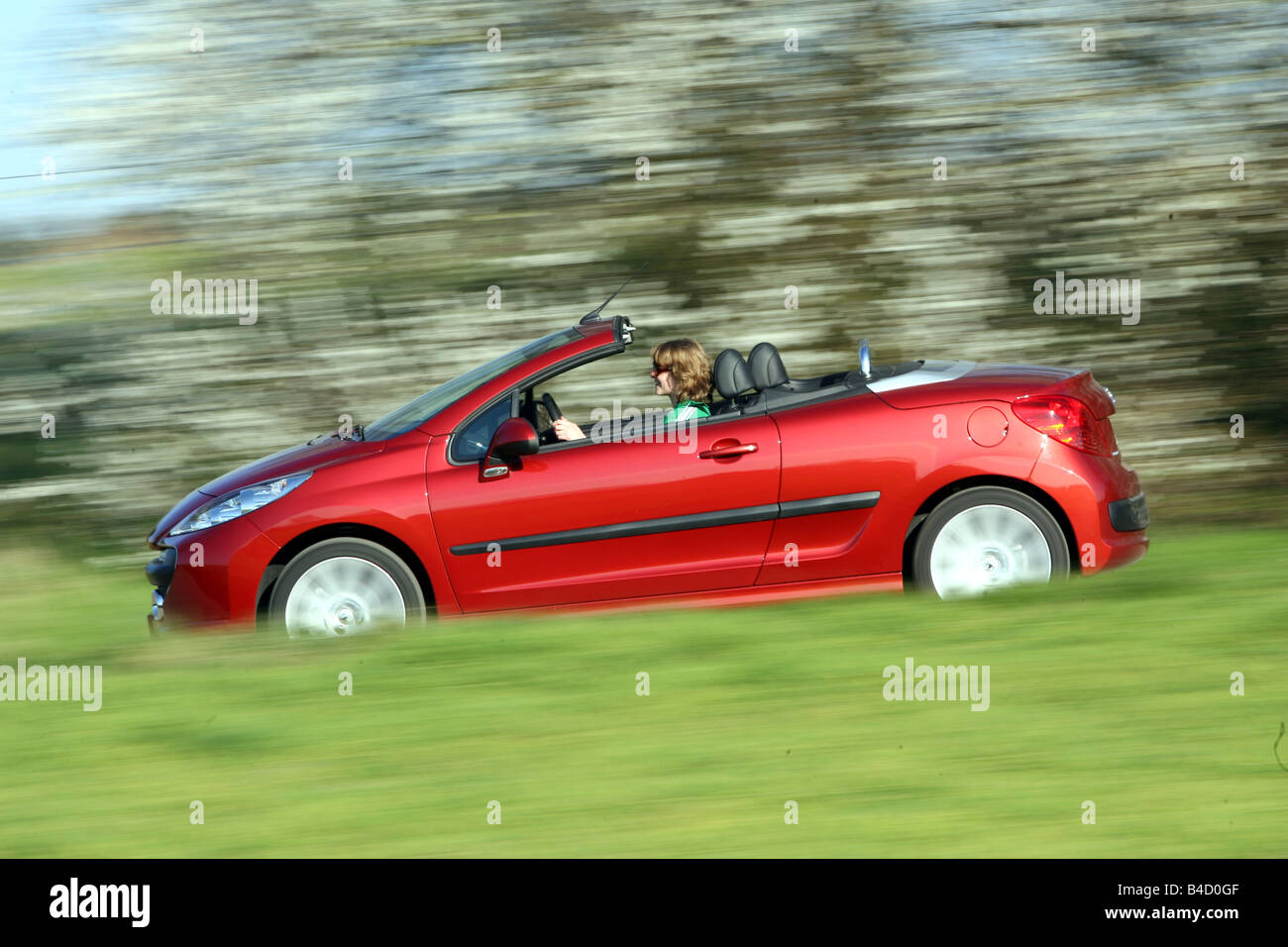 Peugeot 207 CC, model year 2007-, red, driving, side view, country road,  open top Stock Photo - Alamy