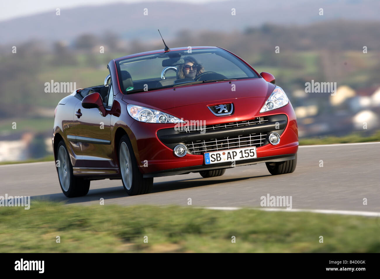 Peugeot 207 CC, model year 2007-, red, driving, diagonal from the front,  frontal view, country road, open top Stock Photo - Alamy