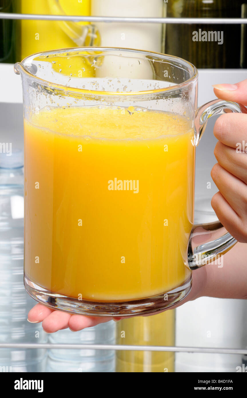 PUTTING JUG OF ORANGE JUICE IN FRIDGE Stock Photo Alamy