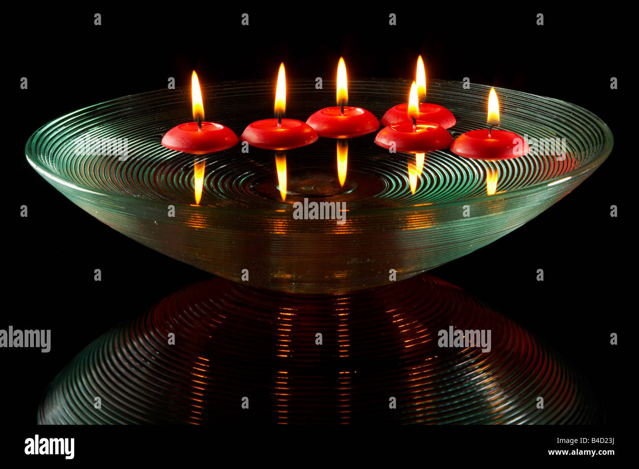 Six red christmas candles floating on water Stock Photo Alamy