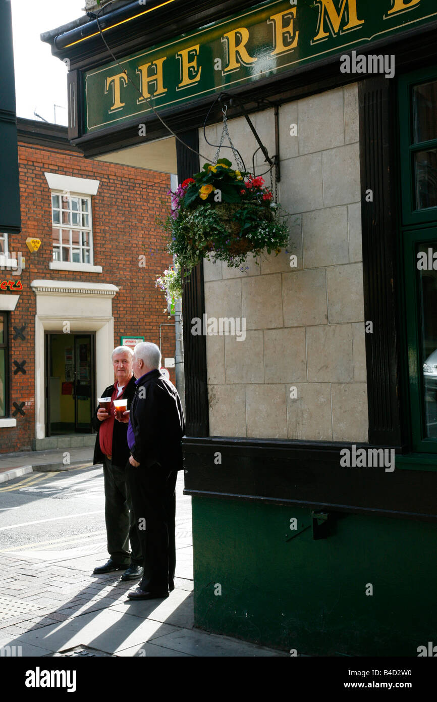 Aug 2008 - Men standing outside a pub Manchester England UK Stock Photo