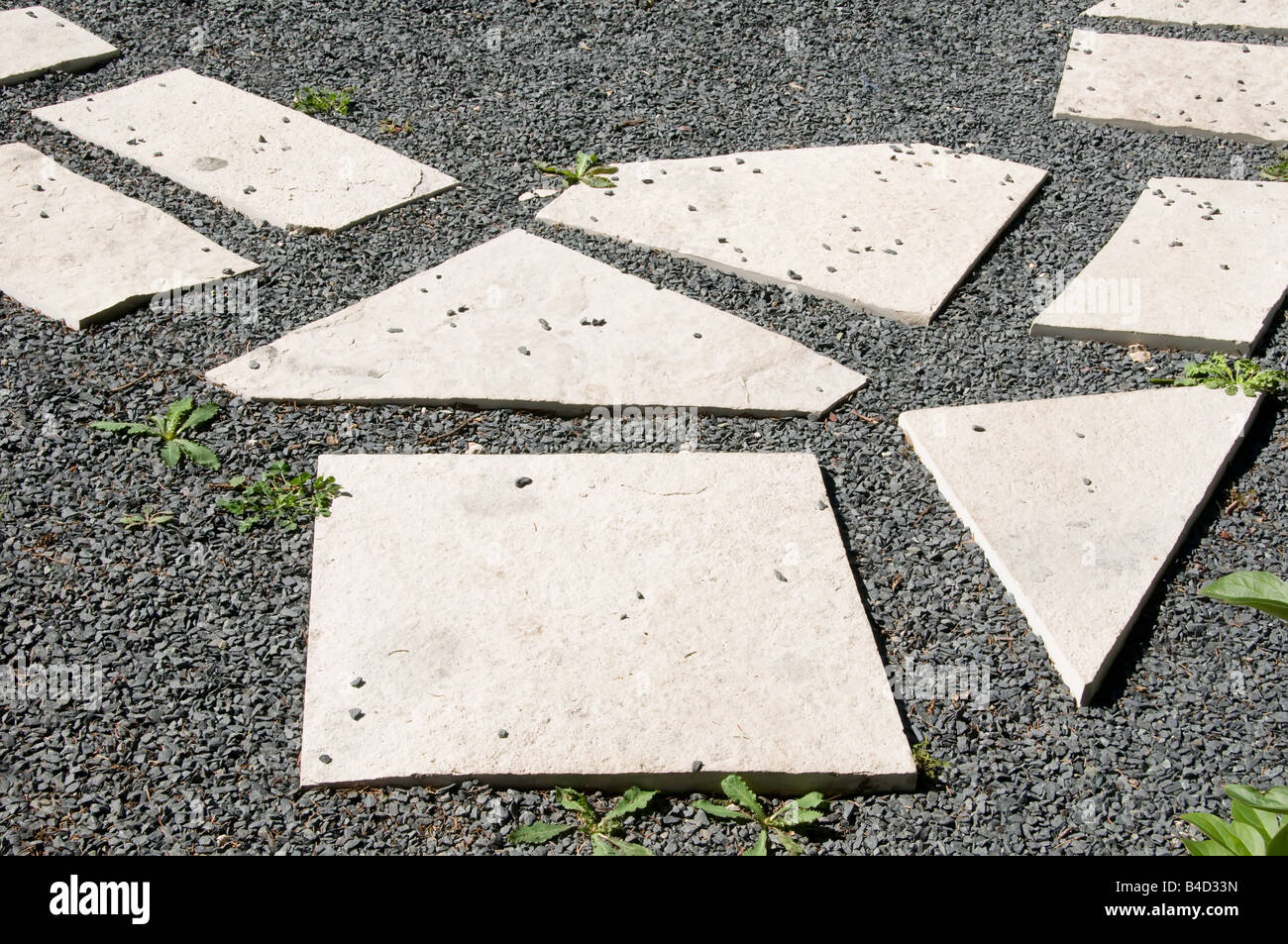 Bright stepping stones on gray gravel in garden Stock Photo