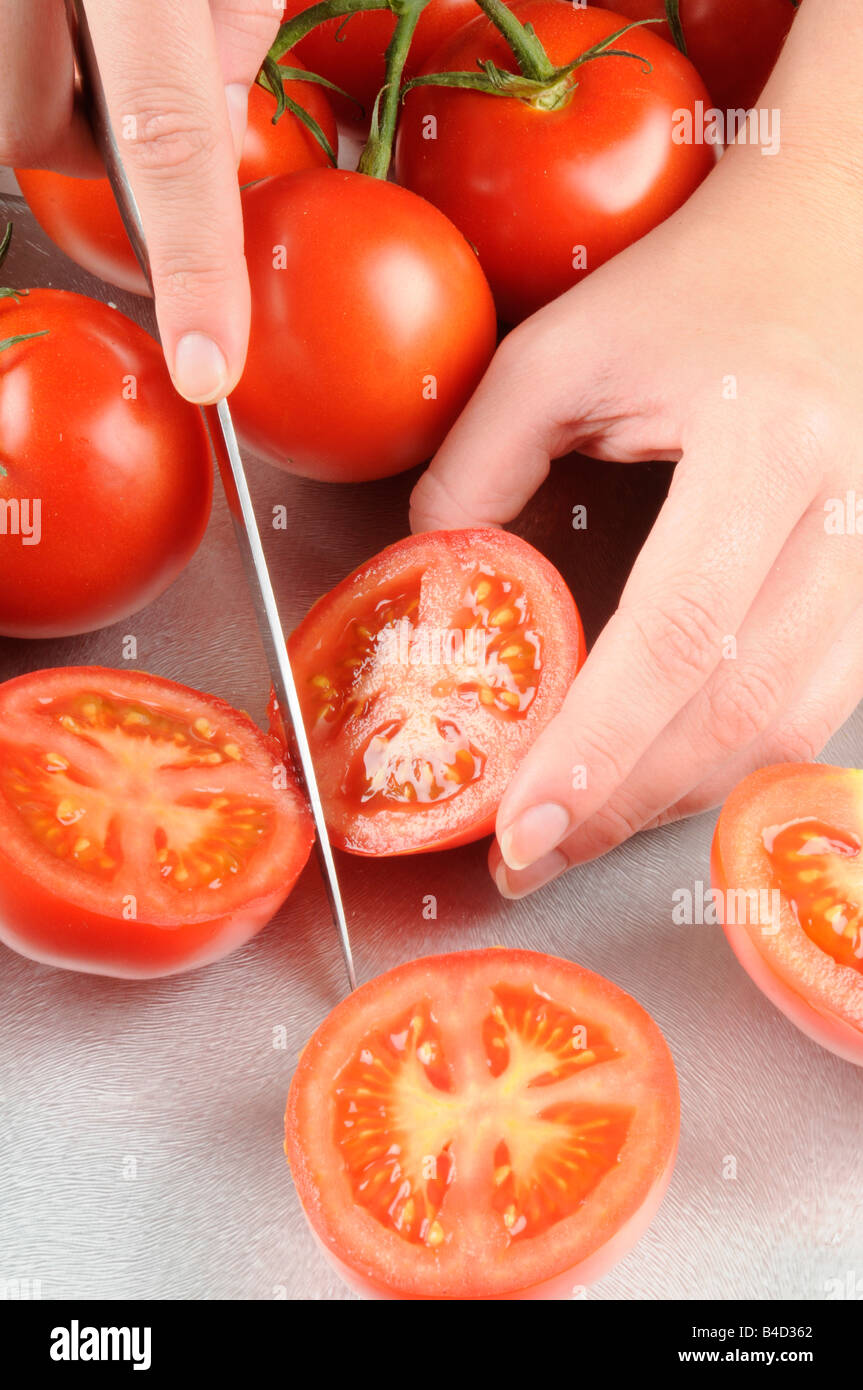 WOMAN SLICING TOMATOES Stock Photo - Alamy
