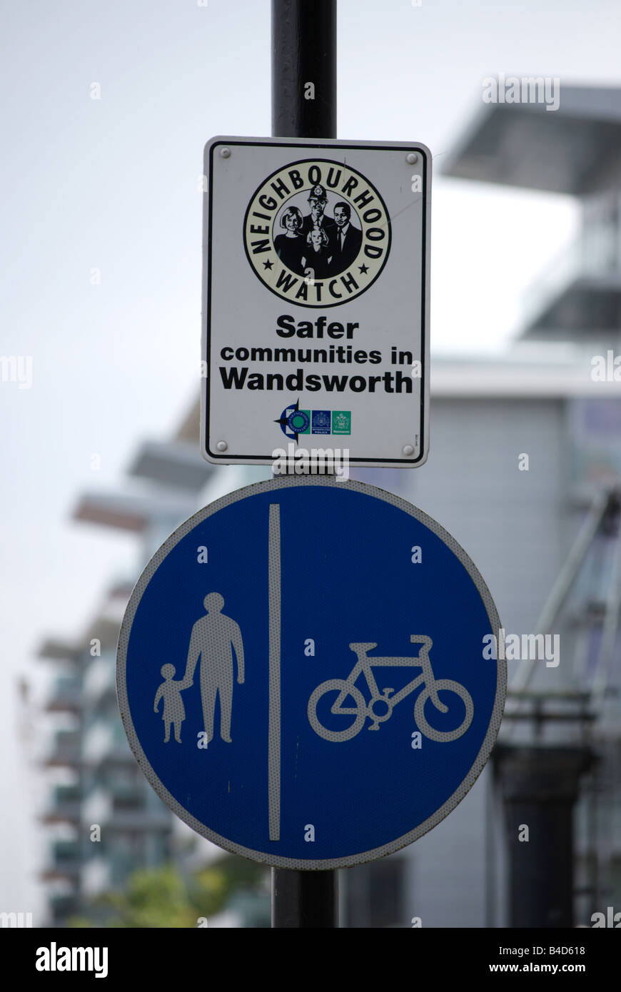 signs indicating separate lanes for pedestrian and cyclists and aneighbourhood watch area, wandsworth, london, england Stock Photo