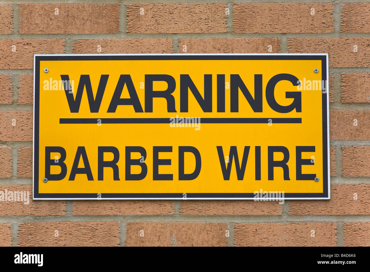 Barbed Wire sign on building, England Stock Photo