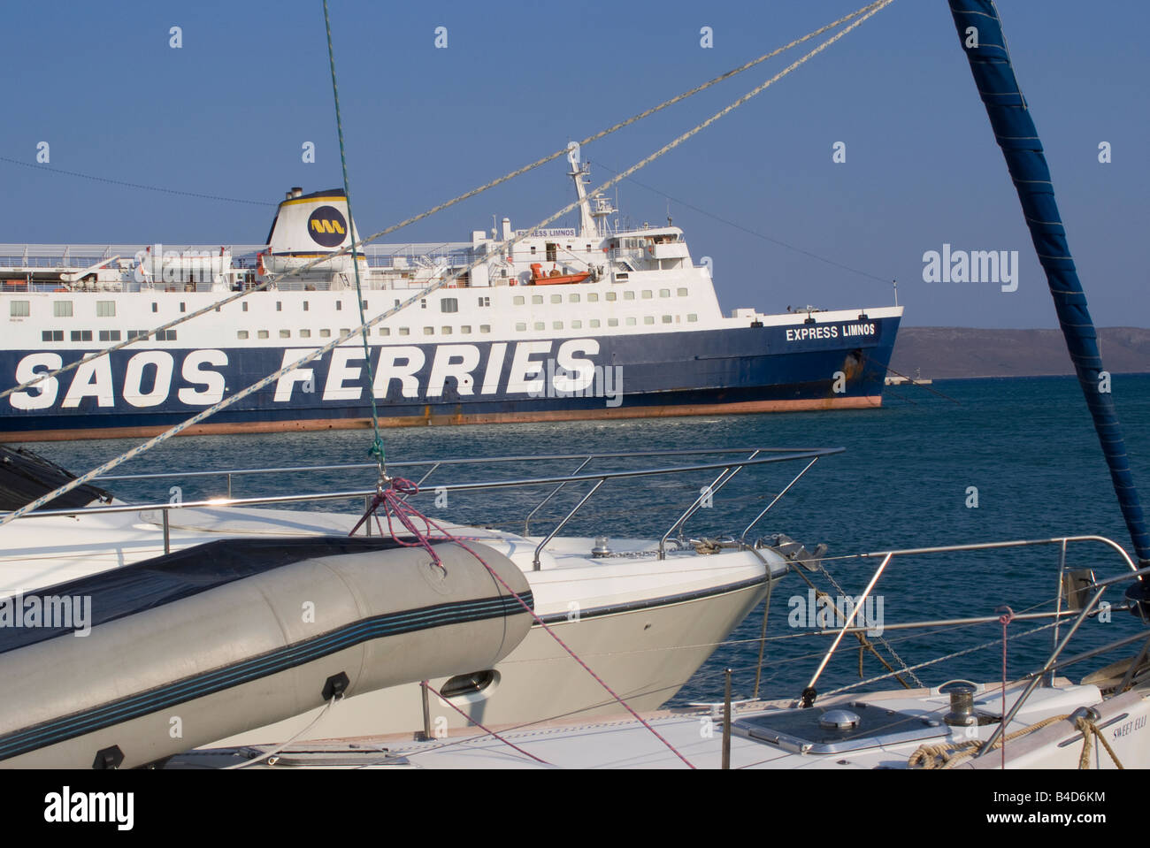 View of Car and Passenger Ferry Through the Rigging of Yachts Moored in Lavrion Town Harbour Greek Mainland Aegean Sea Greece Stock Photo