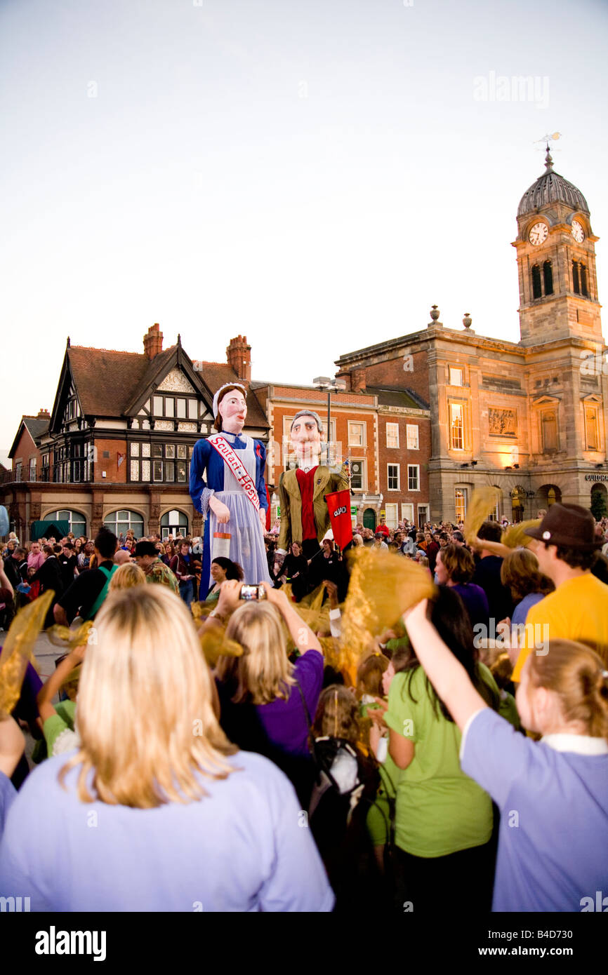 Large Papier-mache puppets and crowds in Derby City market place during the Derby Feste. Stock Photo