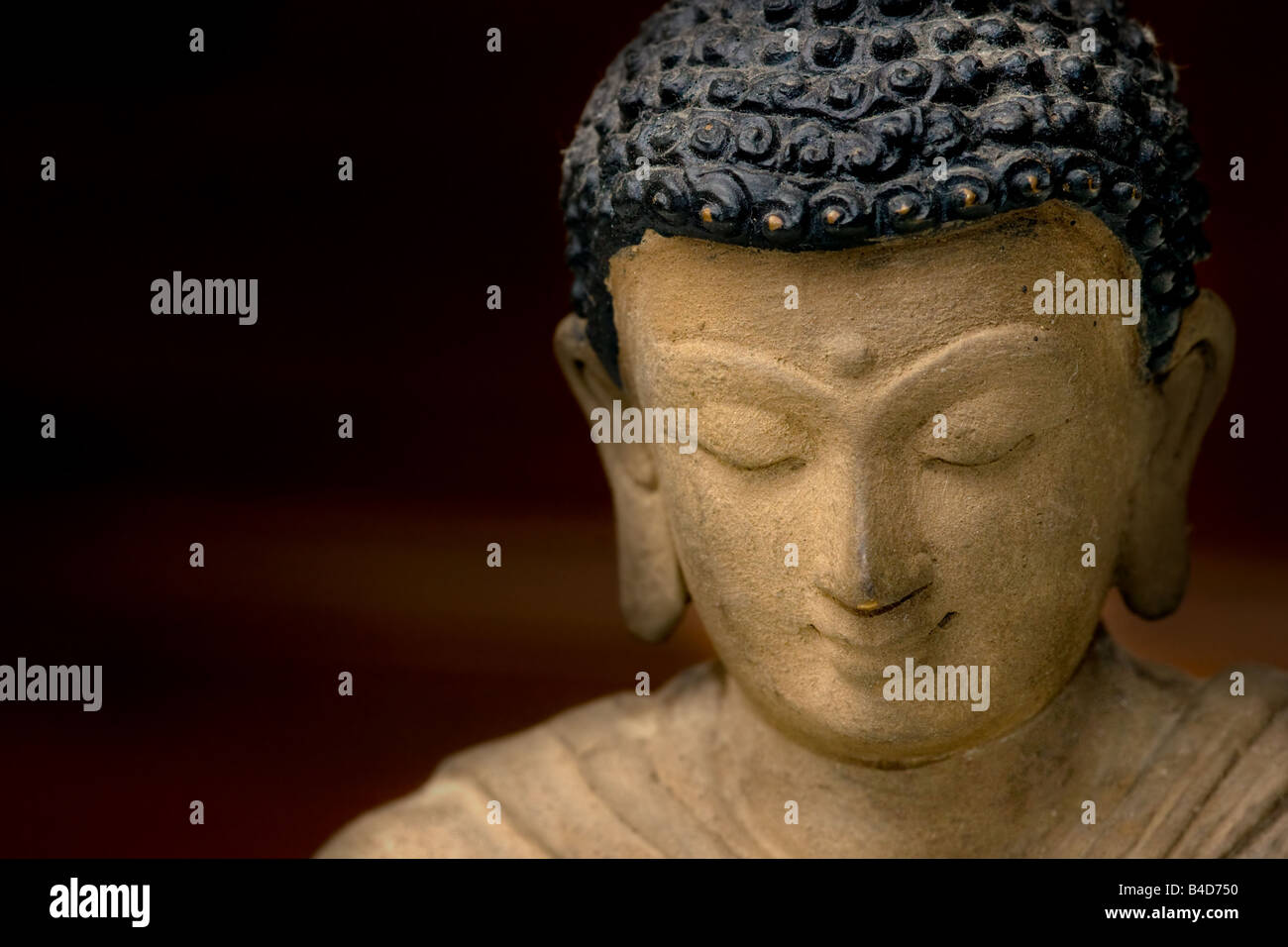 Close up picture of a Buddha Face in Bronze from Nepal Stock Photo