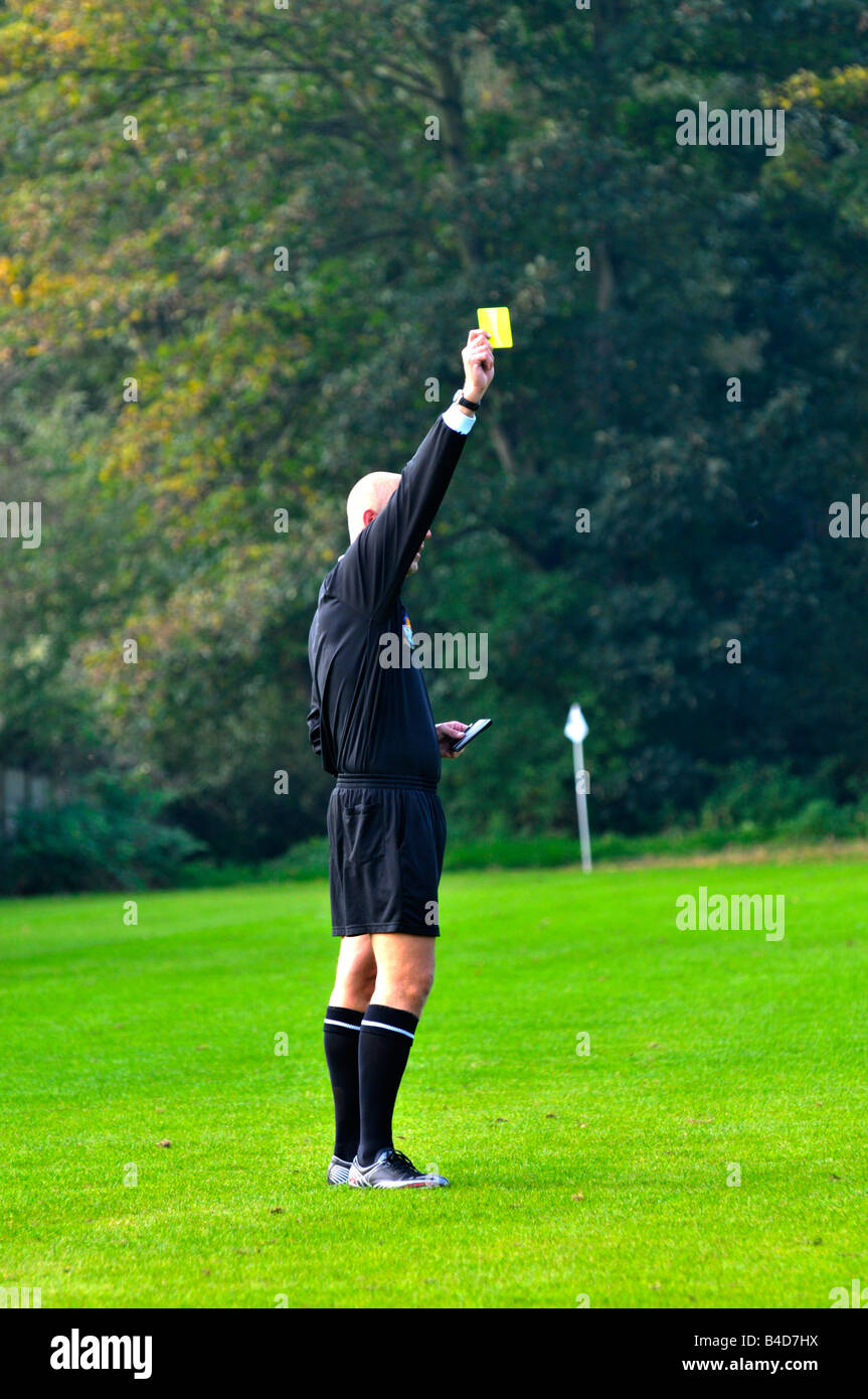 football referee shows yellow card Stock Photo