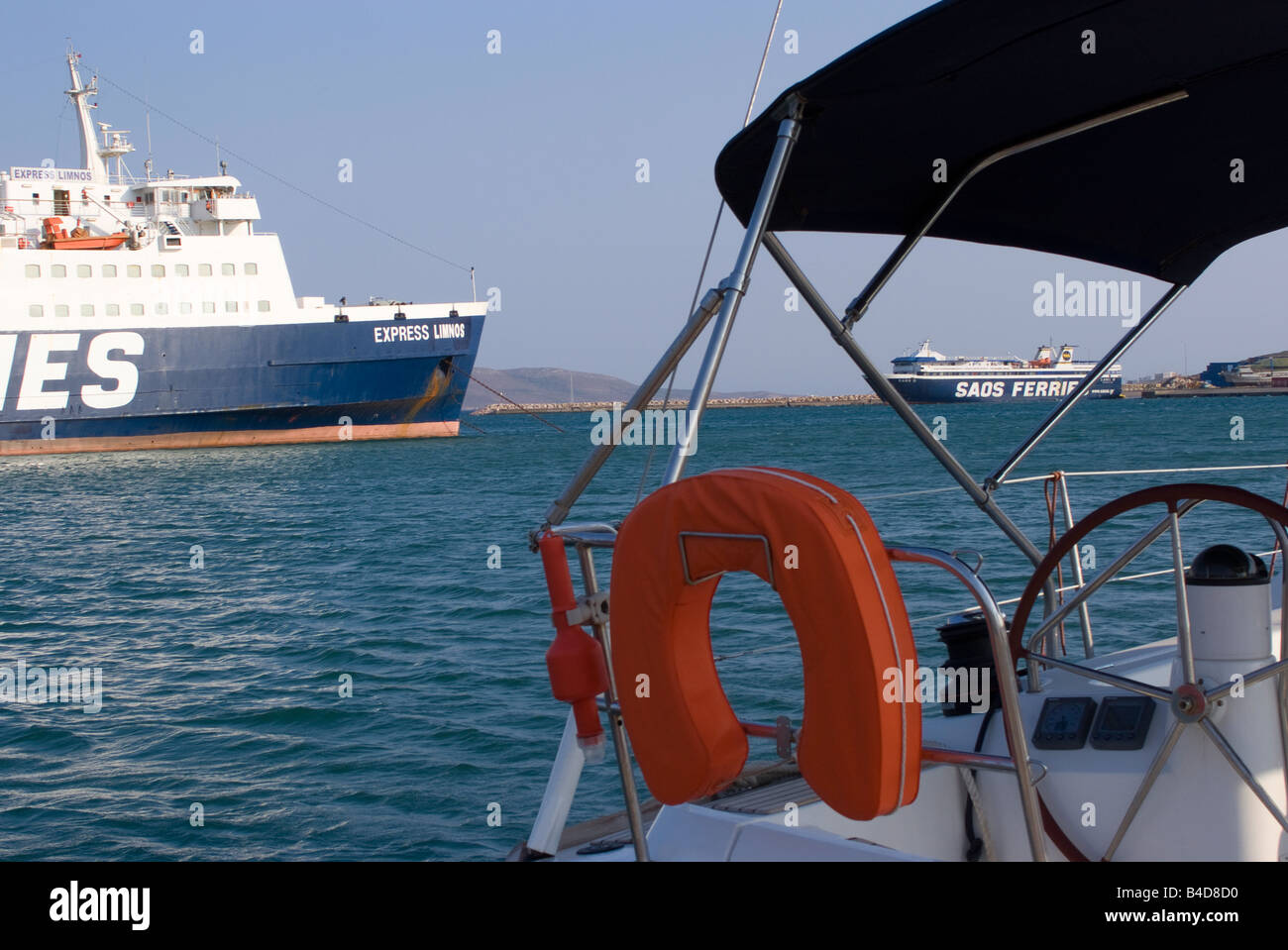 View of Car and Passenger Ferries Through Cockpit Area of Yacht Moored in Lavrion Town Harbour Greek Mainland Aegean Sea Greece Stock Photo