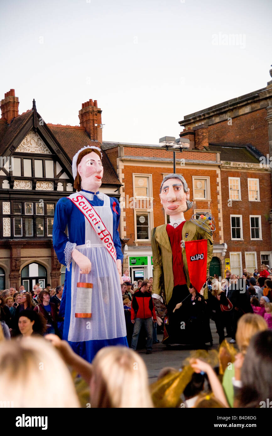 Large Papier-mache puppets and crowds in Derby City market place during the Derby Feste. Stock Photo
