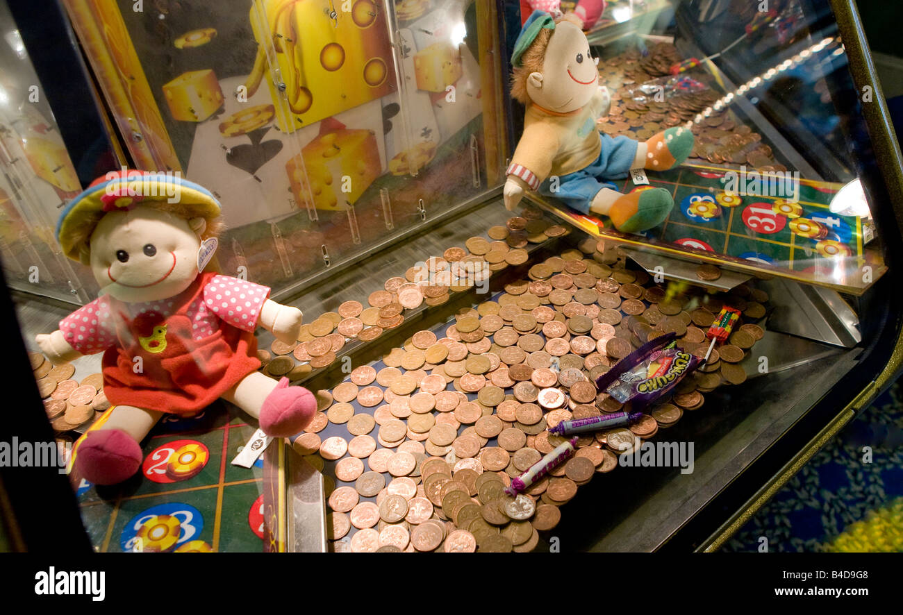 Twopenny Coins In A Machine At The Penny Arcade On Brighton Pier Sussex UK Europe ying Stock Photo