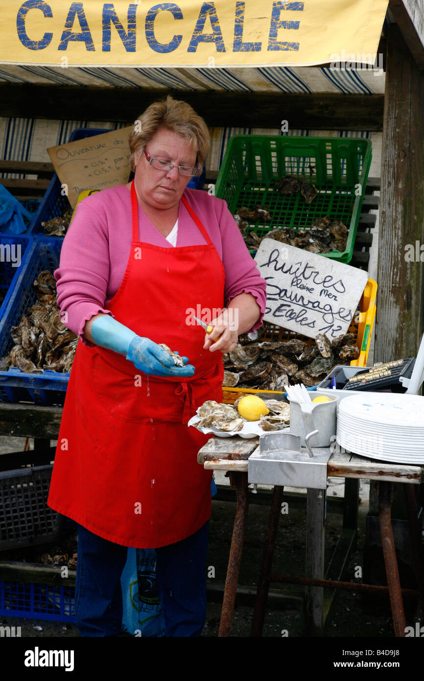 July 2008 - Woman selling oysters at the market by the prot in Cancale Brittany France Stock Photo