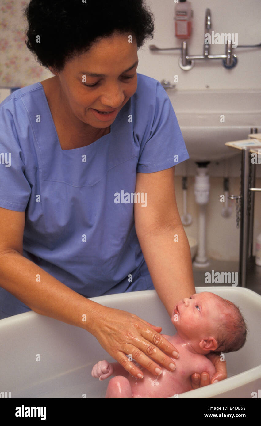 midwife bathing newborn baby in delivery suite Stock Photo Alamy