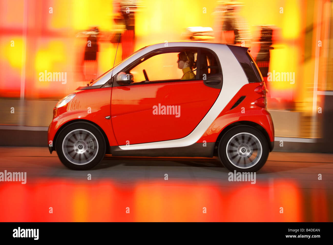 Smart Fortwo Passion, model year 2007-, red, driving, side view, City Stock Photo