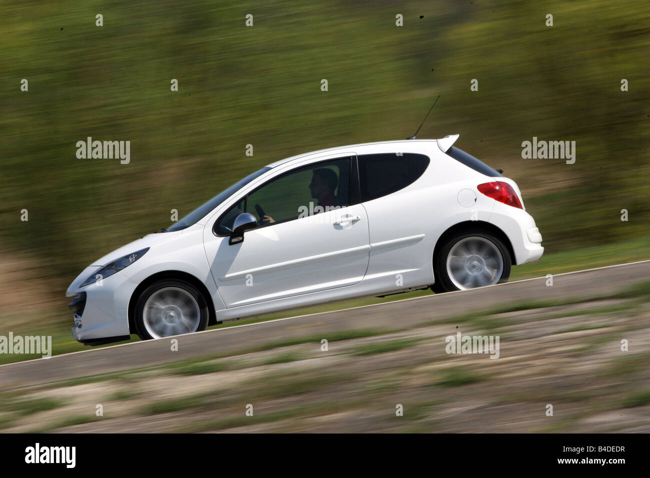 Peugeot 207 RC Cup 175 THP, model year 2007-, white, driving, side view, country road Stock Photo