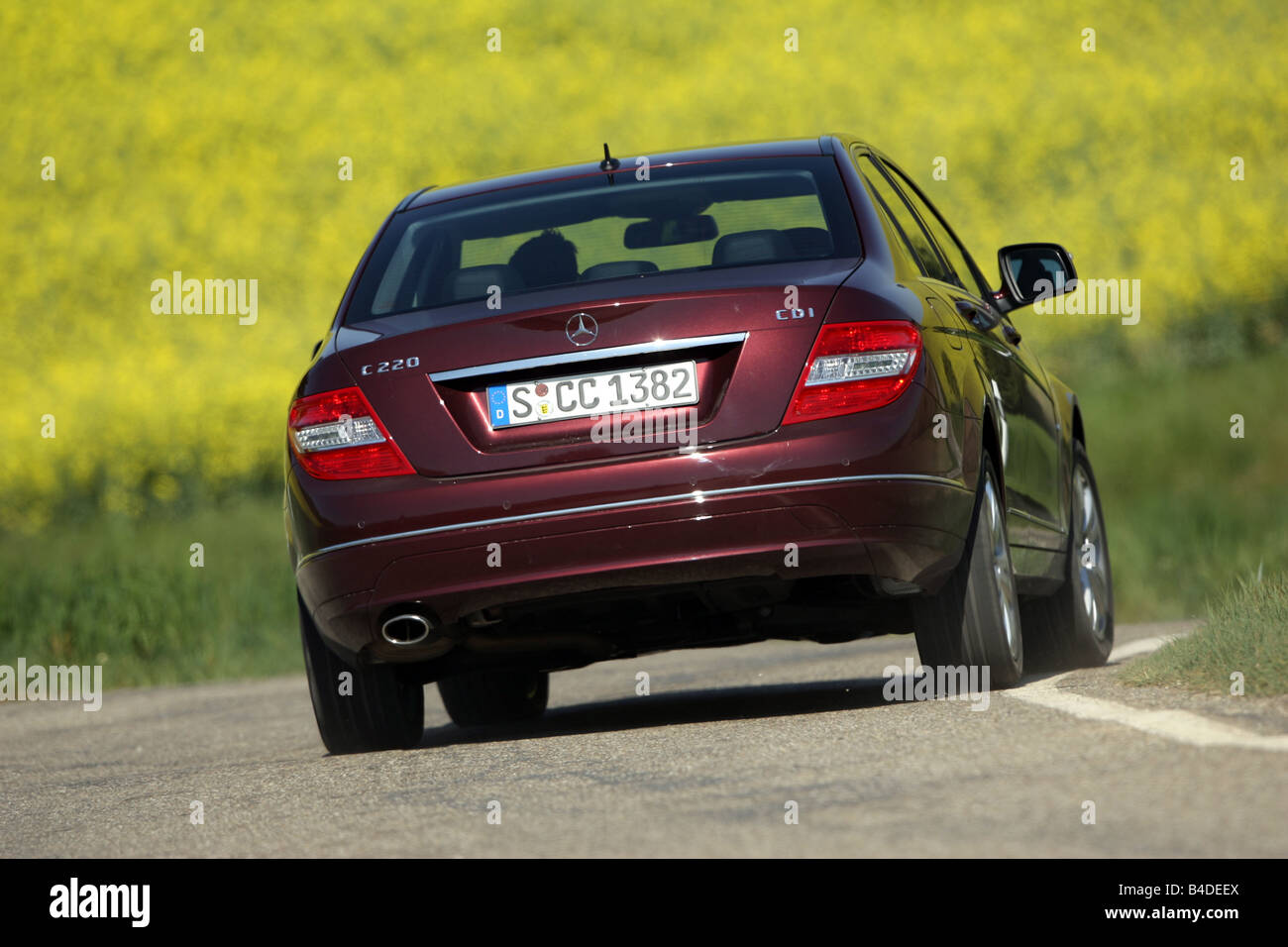 Mercedes C 220 CDI Avantgarde, model year 2007-, ruby colored, driving,  diagonal from the back, rear view, country road Stock Photo - Alamy