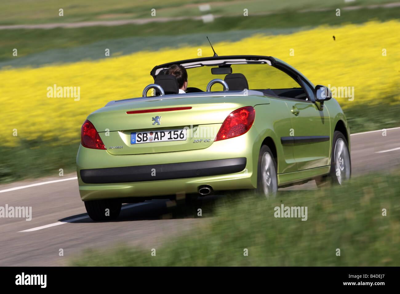Peugeot 207 CC 120 Sport, model year 2007-, green, driving, diagonal from the back, rear view, country road, open top Stock Photo