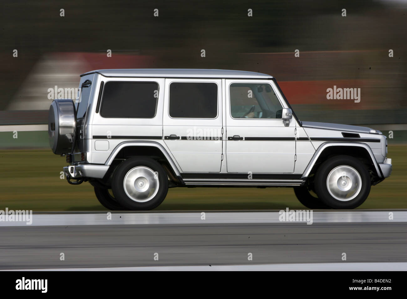 Mercedes G 320 CDI, model year 2007-, silver, driving, side view, country road Stock Photo