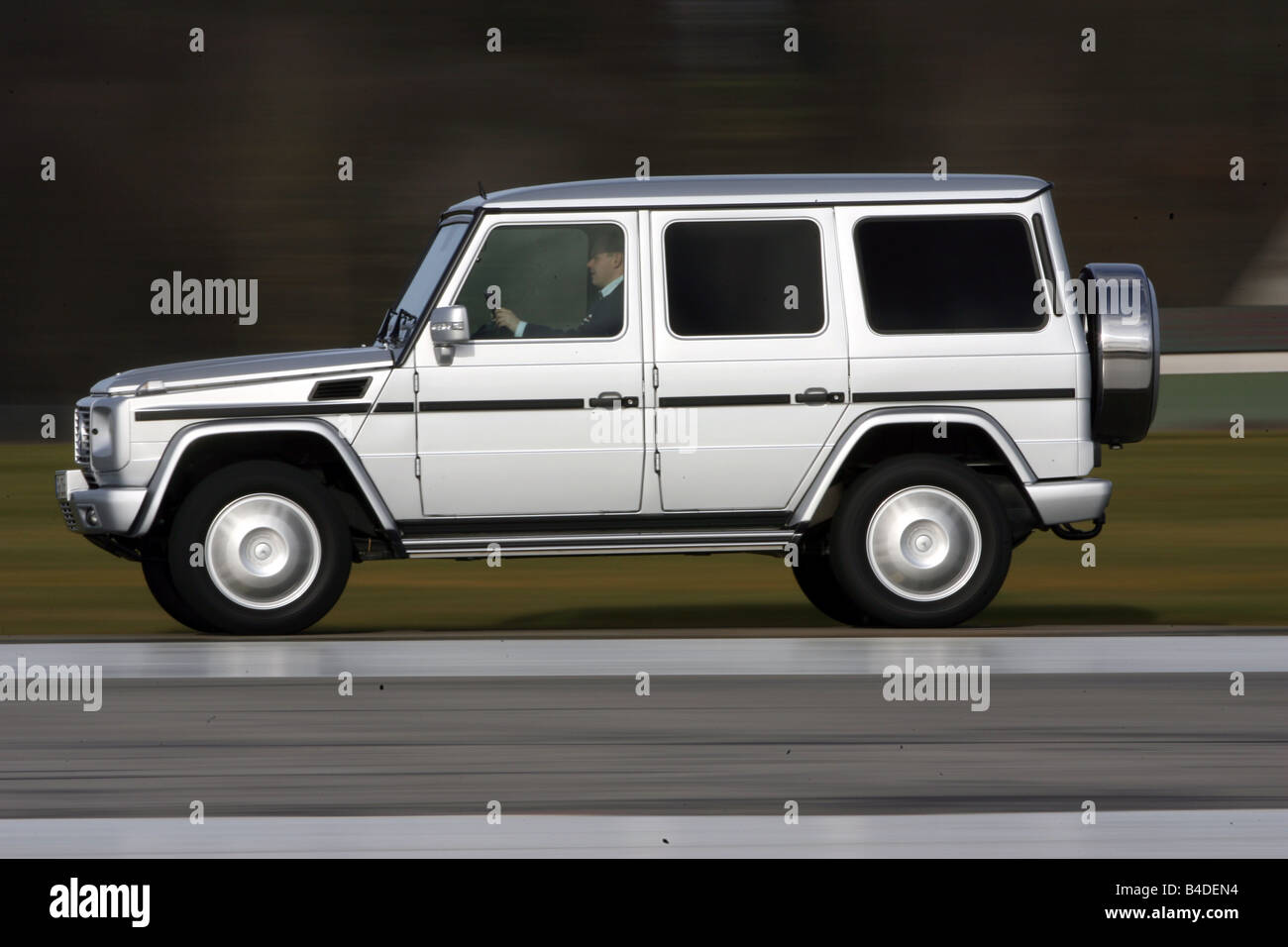 Mercedes G 320 CDI, model year 2007-, silver, driving, side view, country road Stock Photo