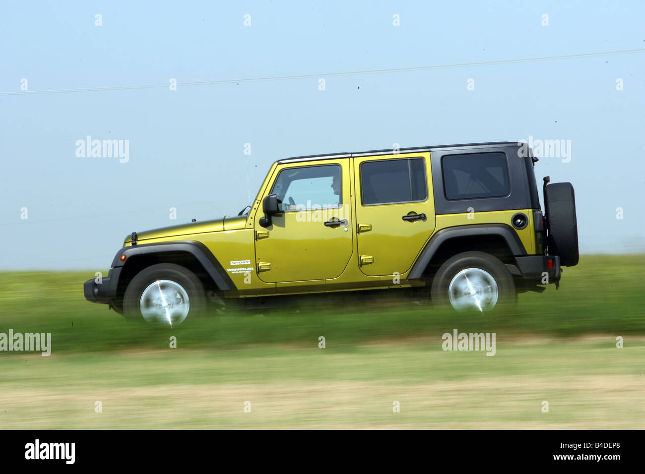 Jeep Wrangler Unlimited  CRD, model year 2007-, green-metallic, driving,  side view, country road Stock Photo - Alamy