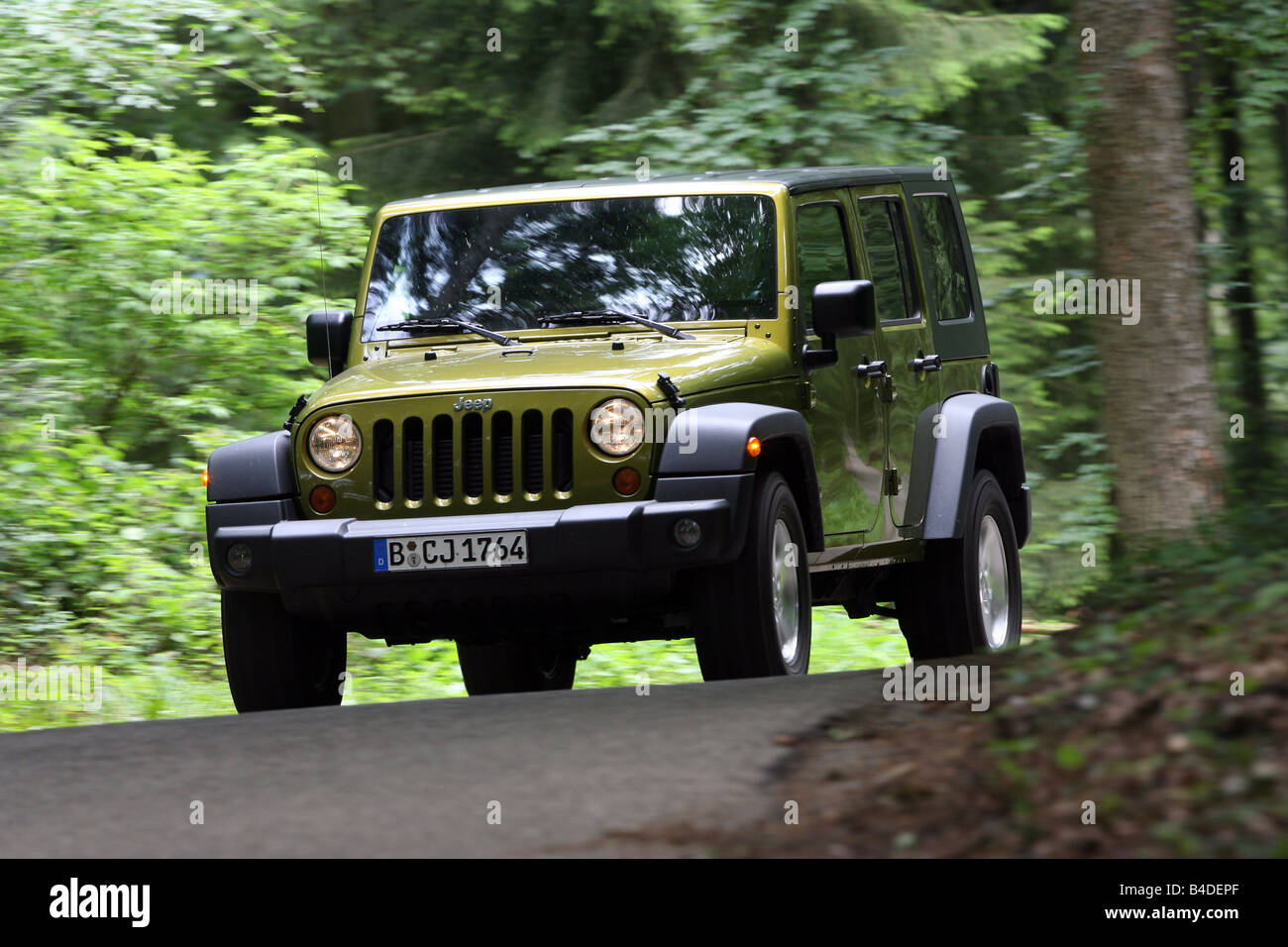 Jeep Wrangler Unlimited  CRD, model year 2007-, green-metallic, driving,  diagonal from the front, frontal view, country road Stock Photo - Alamy