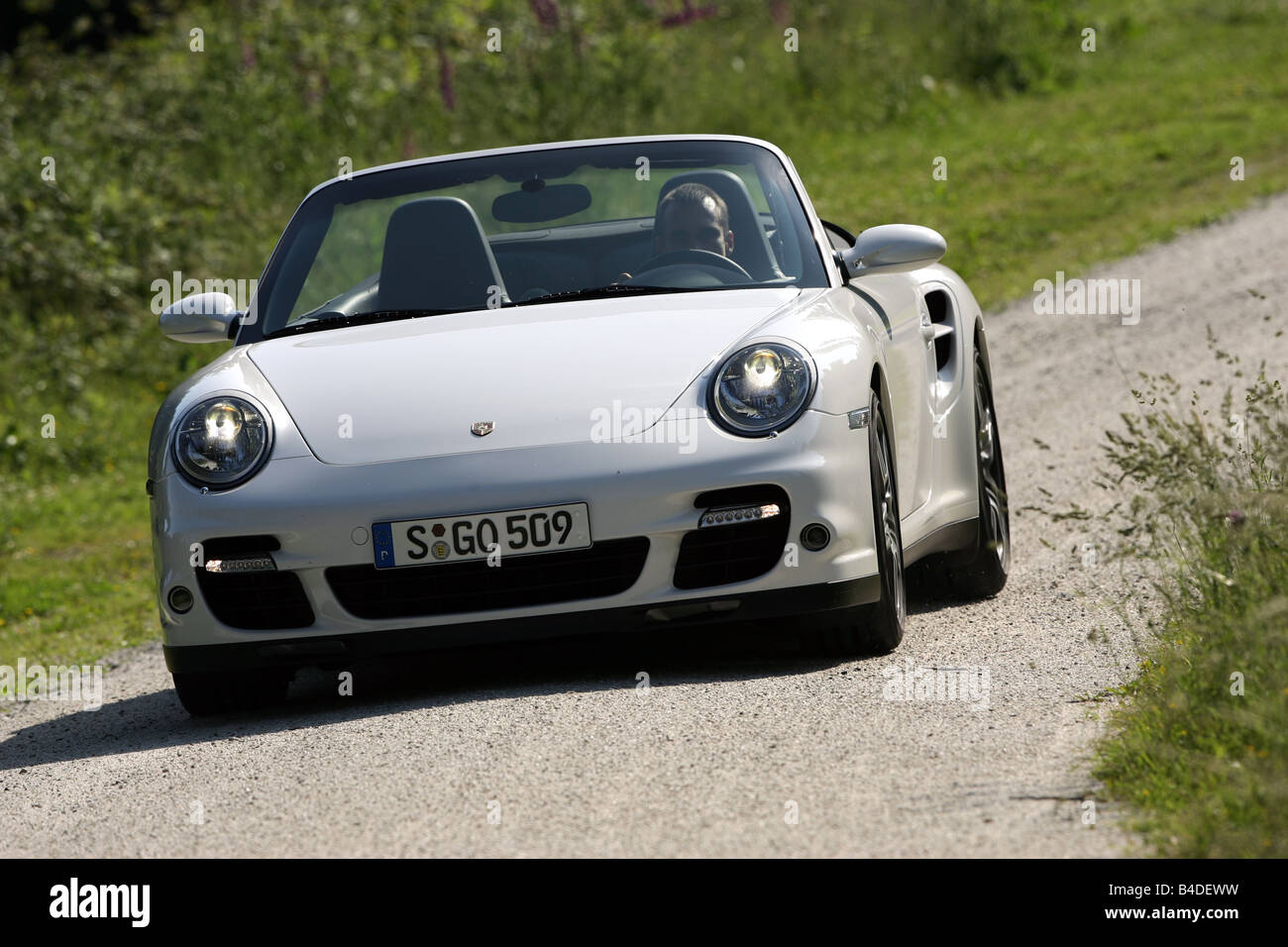 Porsche 911 Turbo Convertible, model year 2007-, white, driving, diagonal from the front, frontal view, country road, landsappro Stock Photo