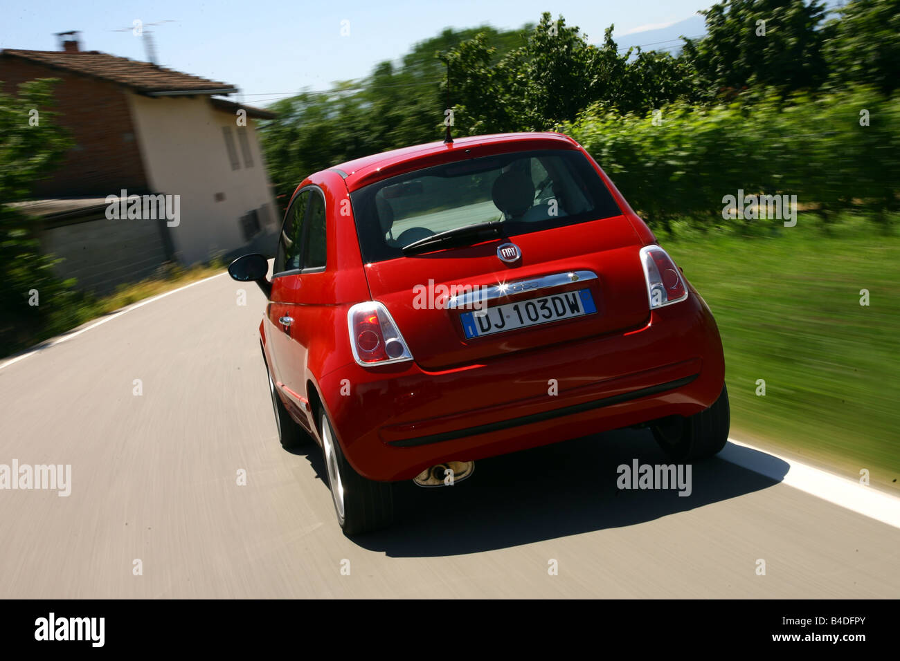 Fiat 500, model year 2007-, red, driving, diagonal from the back, rear view, country road Stock Photo