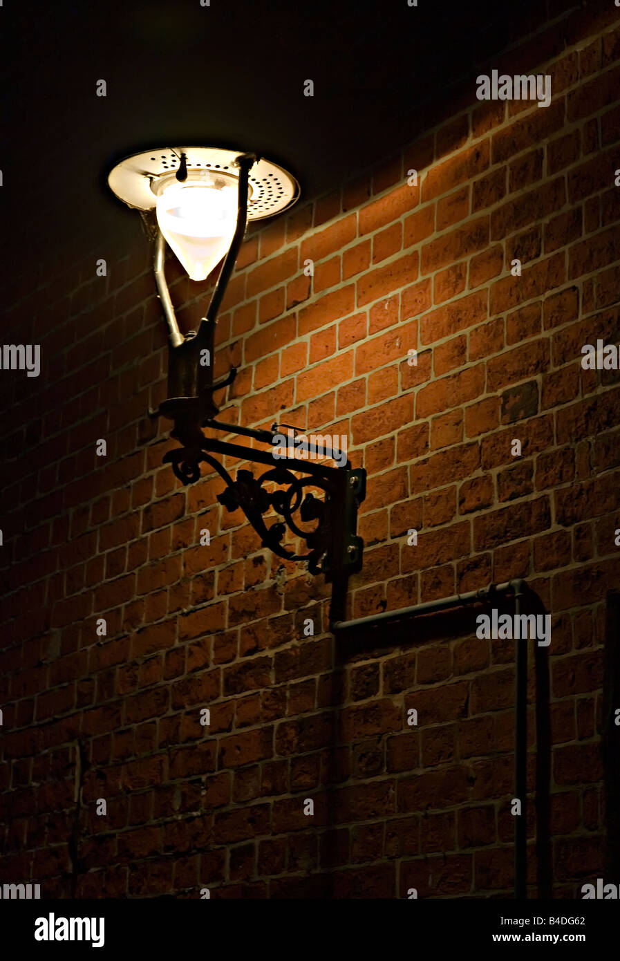 Gas light on wall of back street Lubeck Germany Stock Photo