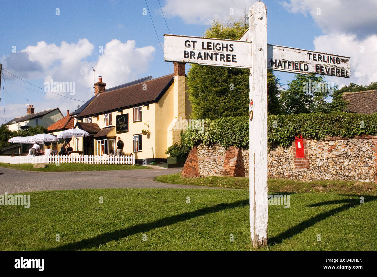 village signpost and the Square Compass pub Fairstead Essex England Stock Photo
