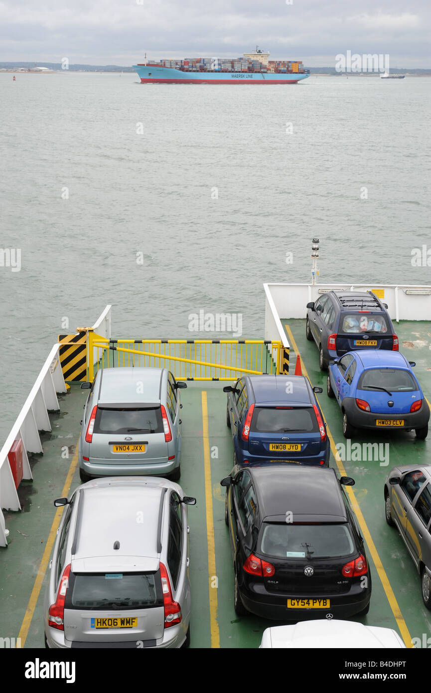 Red Funnel Car Ferry with Container ship crossing in front Stock Photo