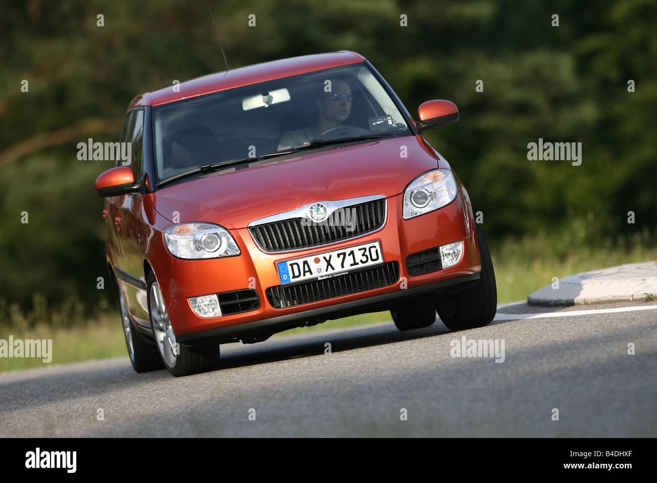 Skoda Fabria 1.4 16V Sport, model year 2007-, orange , driving, diagonal from the front, frontal view, country road Stock Photo