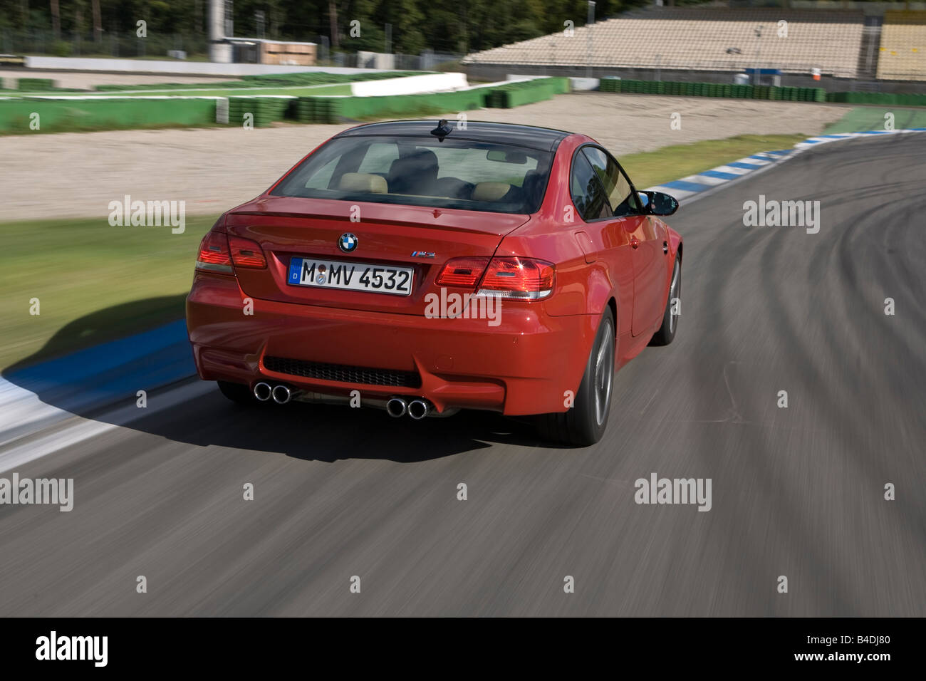 BMW M3 Coupe, model year 2007-, red, driving, diagonal from the back, rear view, test track Stock Photo