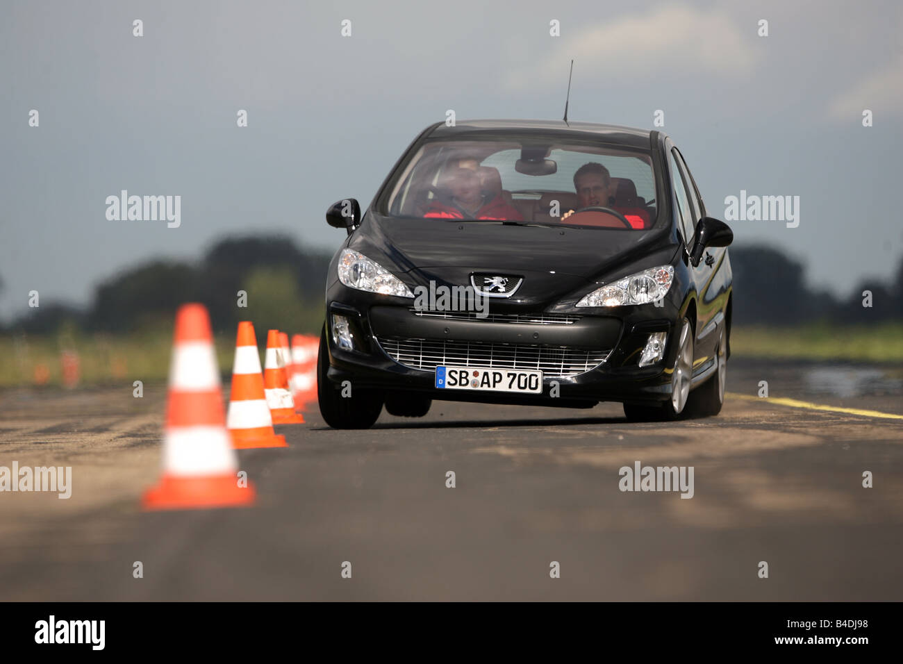 Peugeot 308 HDi FAP 135 Sport Plus, model year 2007-, black, driving, diagonal from the front, frontal view, Pilonen, test track Stock Photo