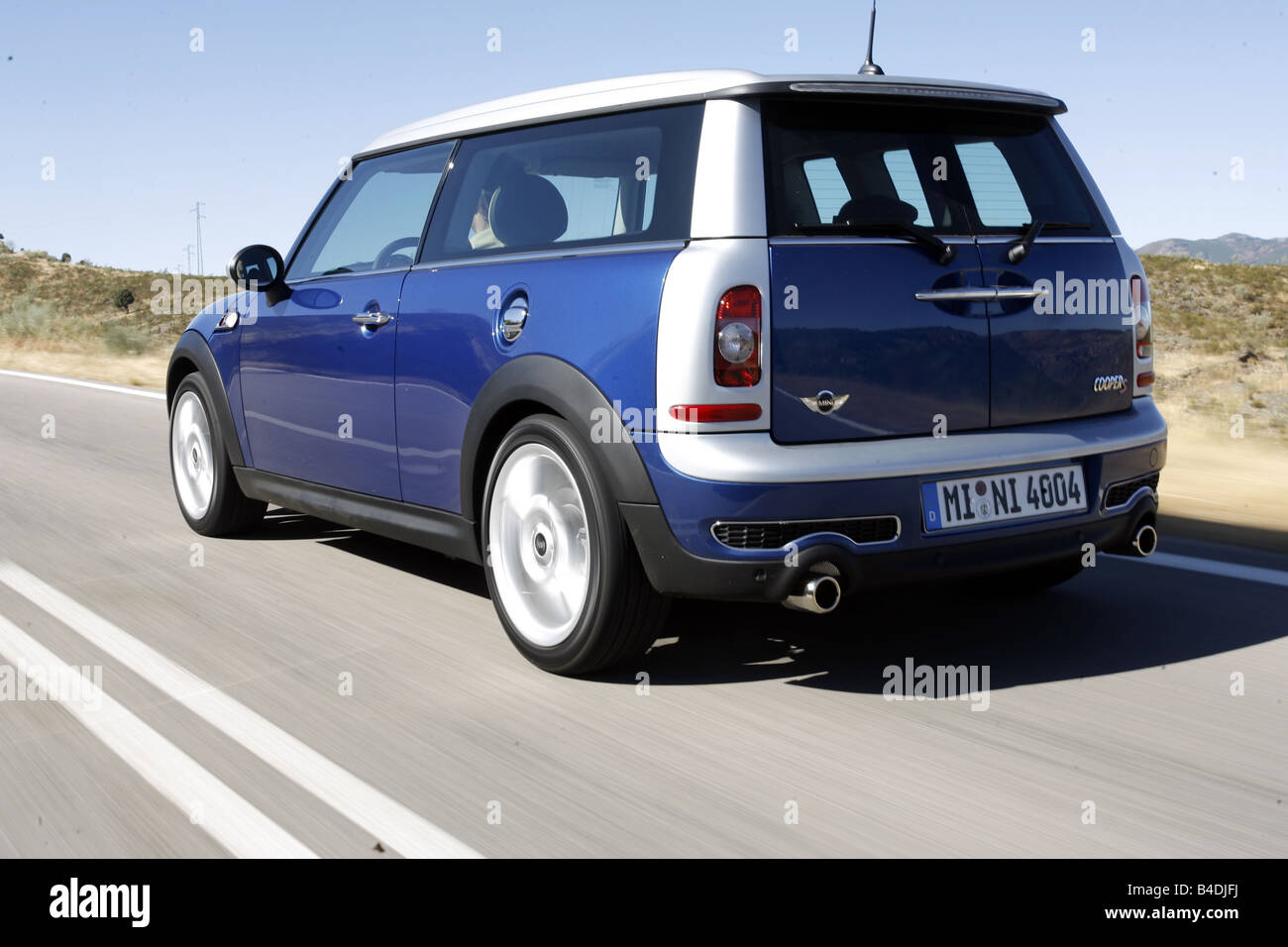 Mini Cooper S Clubman Model Year 07 Blue Moving Diagonal From The Back Rear View Country Road Stock Photo Alamy