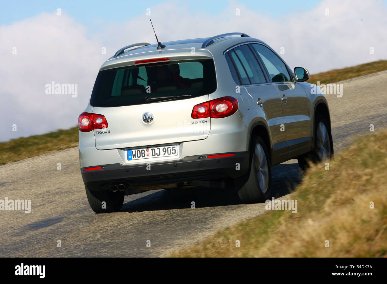 VW Volkswagen Tiguan 2.0 Sport & Style, model year 2007-, silver, driving, diagonal from the back, rear view, country road Stock Photo