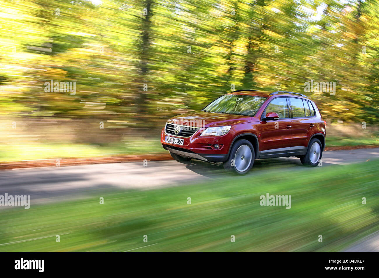 VW Volkswagen Tiguan 1.4 TSI Track & Field, model year 2007-, red, driving, diagonal from the front, frontal view, country road Stock Photo