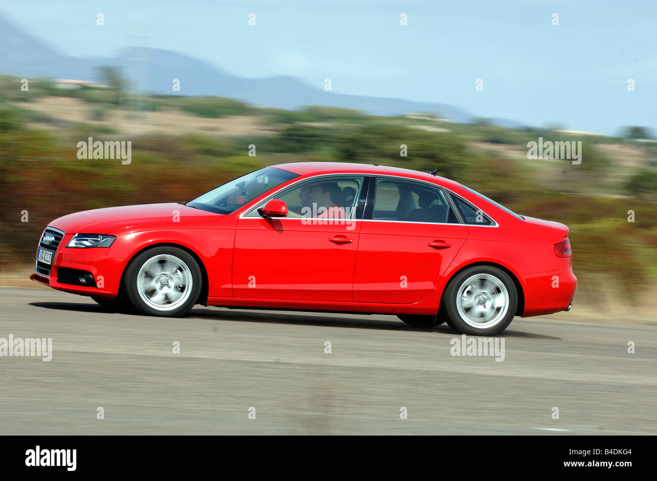 Audi A4 1.8 TFSI Ambition, model year 2007-, red, driving, side view, country road Stock Photo