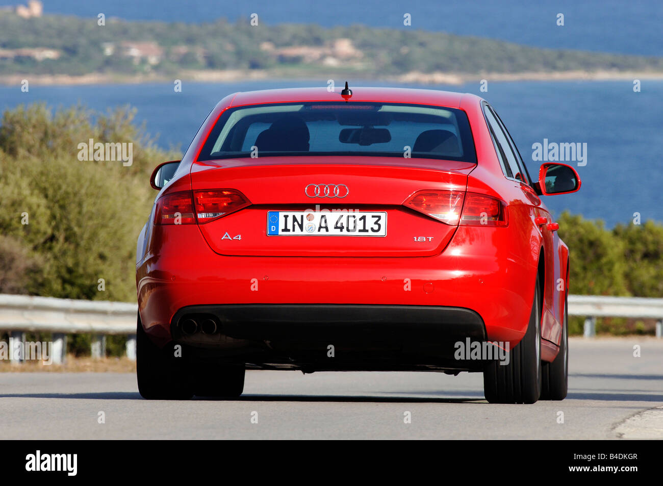 Audi A4 1.8 TFSI Ambition, model year 2007-, red, driving, diagonal from the back, rear view, country road Stock Photo